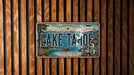 A vintage license plate from Lake Tahoe, California, Nevada, featuring a scenic image of the lake and mountains.