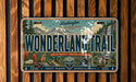 A vintage-style license plate with a mountain landscape and the text "Wonderland Trail" prominently displayed.