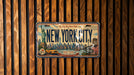 A vintage New York City license plate is displayed on a wooden wall.
