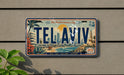 A license plate with the text "Tel Aviv" on it, featuring a cityscape and beach scene.
