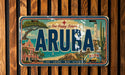 A vintage license plate from the island of Aruba, featuring a colorful illustration of the island's landmarks and scenery.