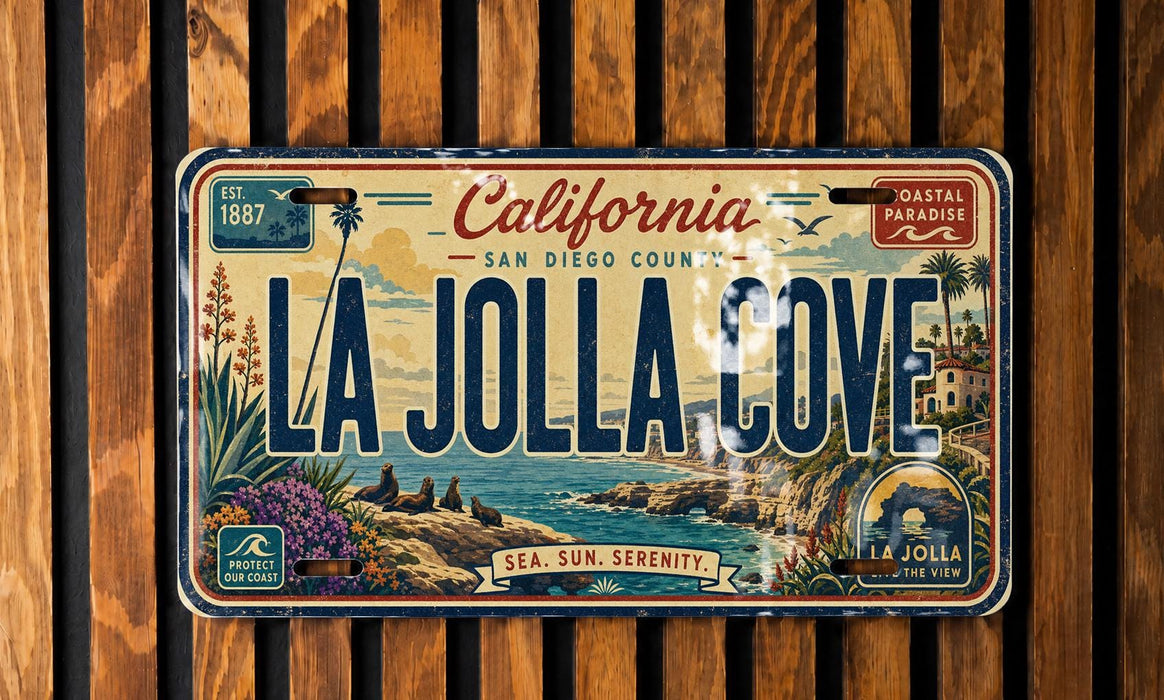 A vintage California license plate with the text "LA Jolla Cove" and a coastal landscape illustration.